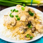 Instant Pot Champagne Chicken over rice on a white plate.