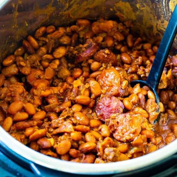 Instant Pot Cowboy Beans in Instant Pot with spoon.