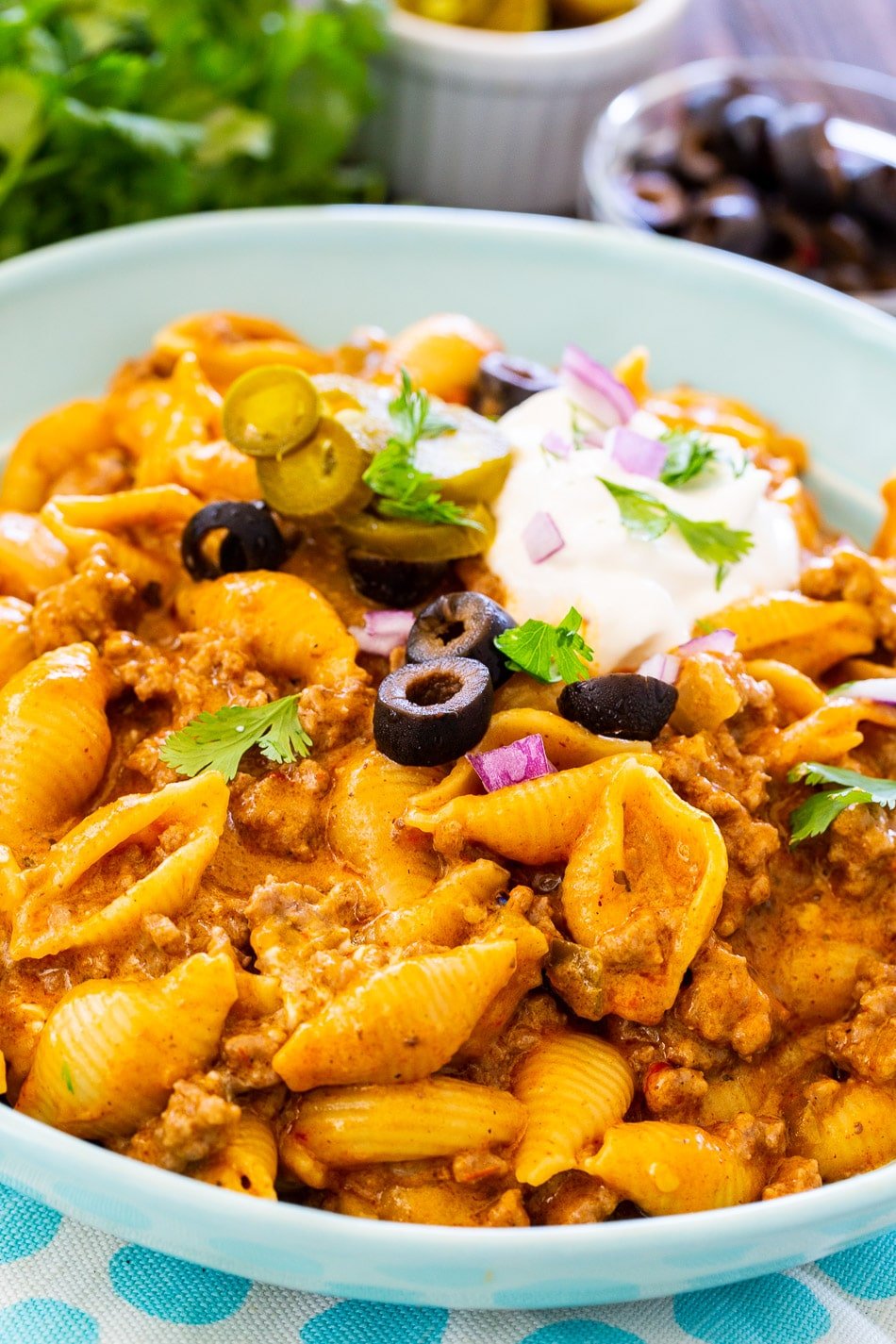 Instant Pot Creamy Taco Pasta in a bowl with toppings.