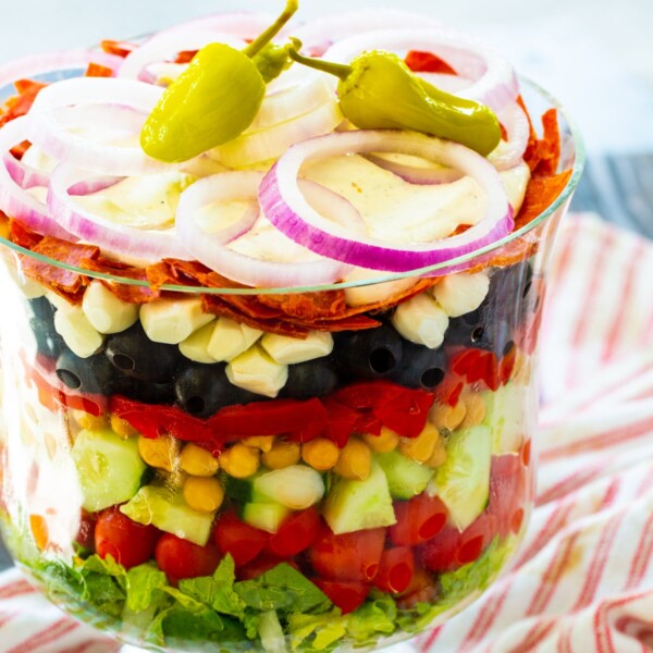 Italian Layered Salad in a trifle bowl.