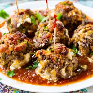 Jalapeno Popper Meatballs on a plate with toothpicks stuck in them.