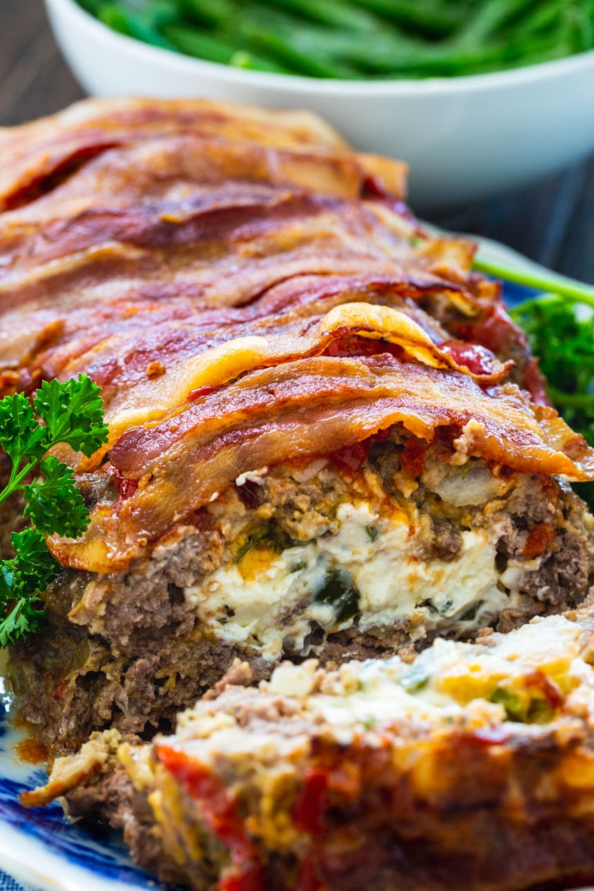 Jalapeno Popper Stuffed Meatloaf with a slice cut to shoe the inside.