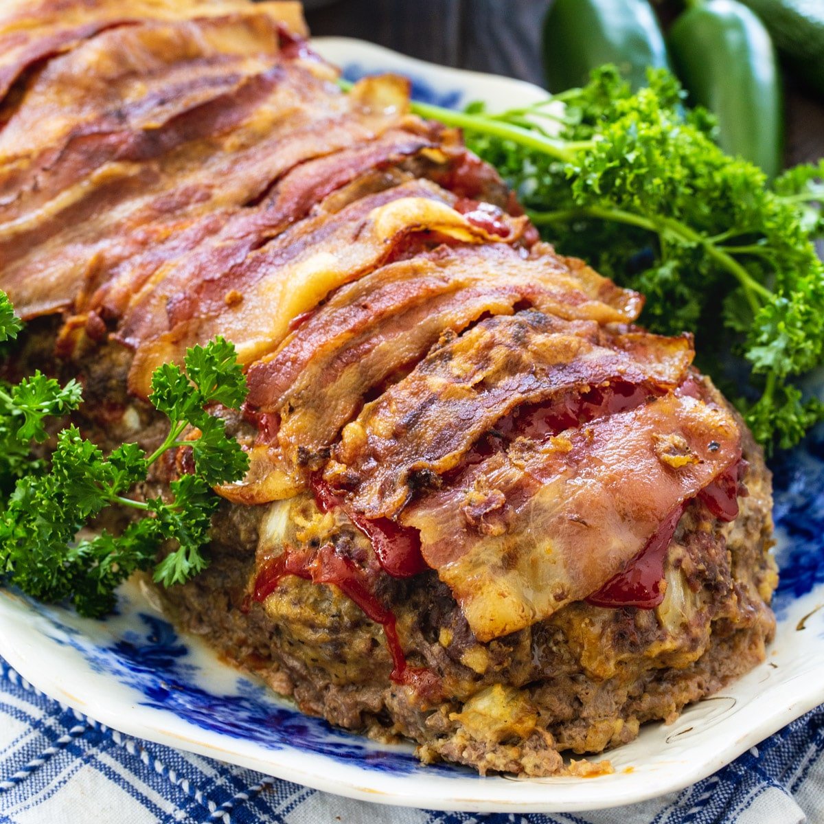 Jalapeno Popper Stuffed Meatloaf on serving platter with parsley.
