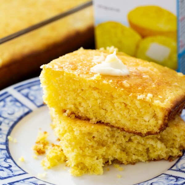 Two pieces of Jiffy Cornbread on a plate.