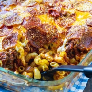 Casserole in baking dish with a spoon scooping a serving.