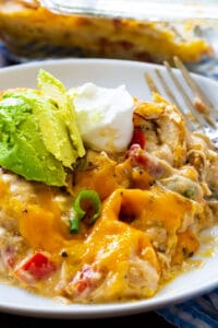 King Ranch Chicken Casserole topped with avocado on a plate.