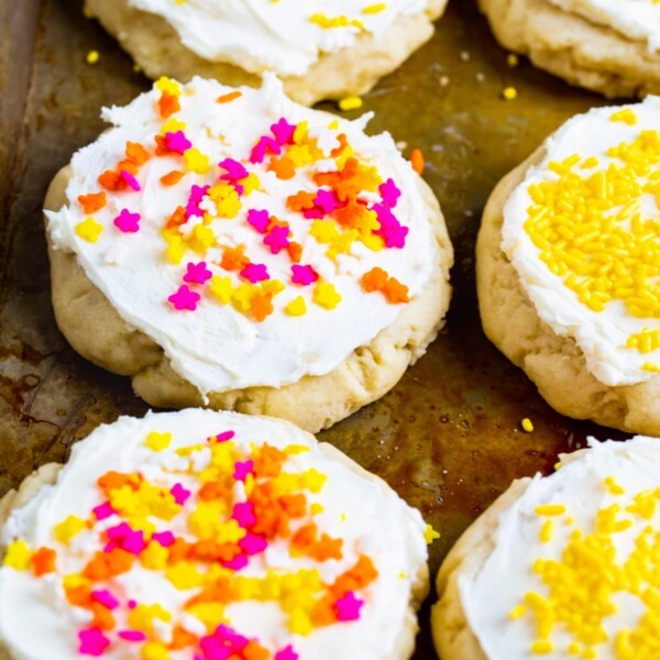 Lofthouse-Style Cookies covered in sprinkles on a baking sheet.