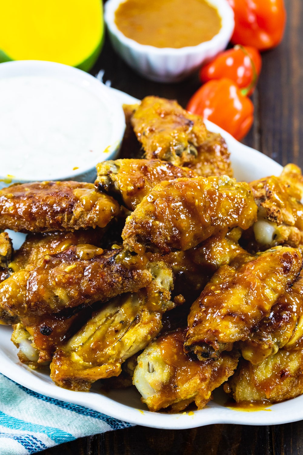 Wings piled up on a plate.