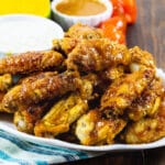 Mango Habanero Chicken Wings on a plate with a bowl of dressing.