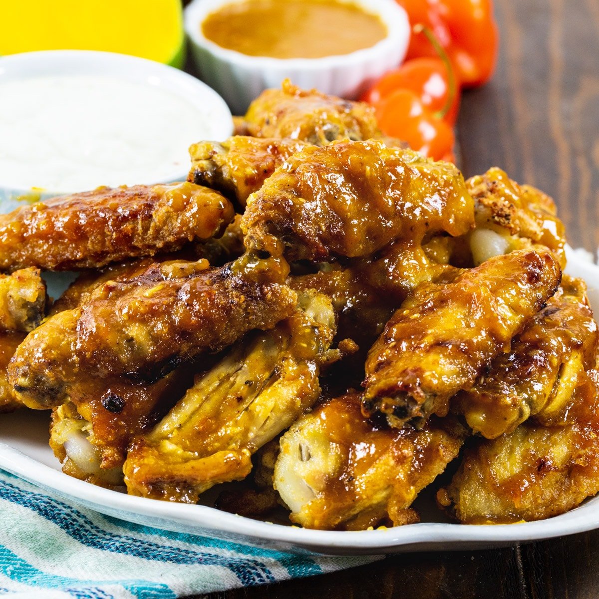 Mango Habanero Chicken Wings on a plate with a bowl of dressing.