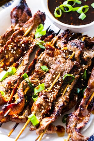 Marinated Steak Skewers with Korean BBQ Sauce on a white serving plate.