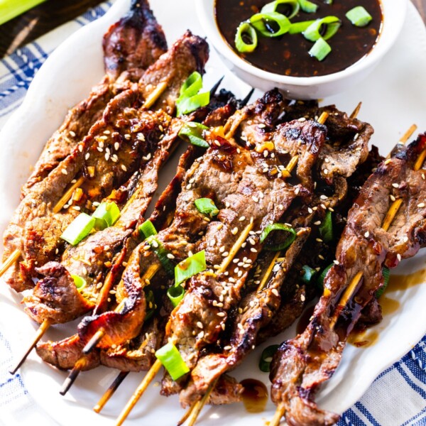 Marinated Steak Skewers with Korean BBQ Sauce on a white serving plate.