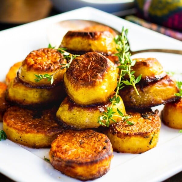 Melting Potatoes piled up on a white plate.