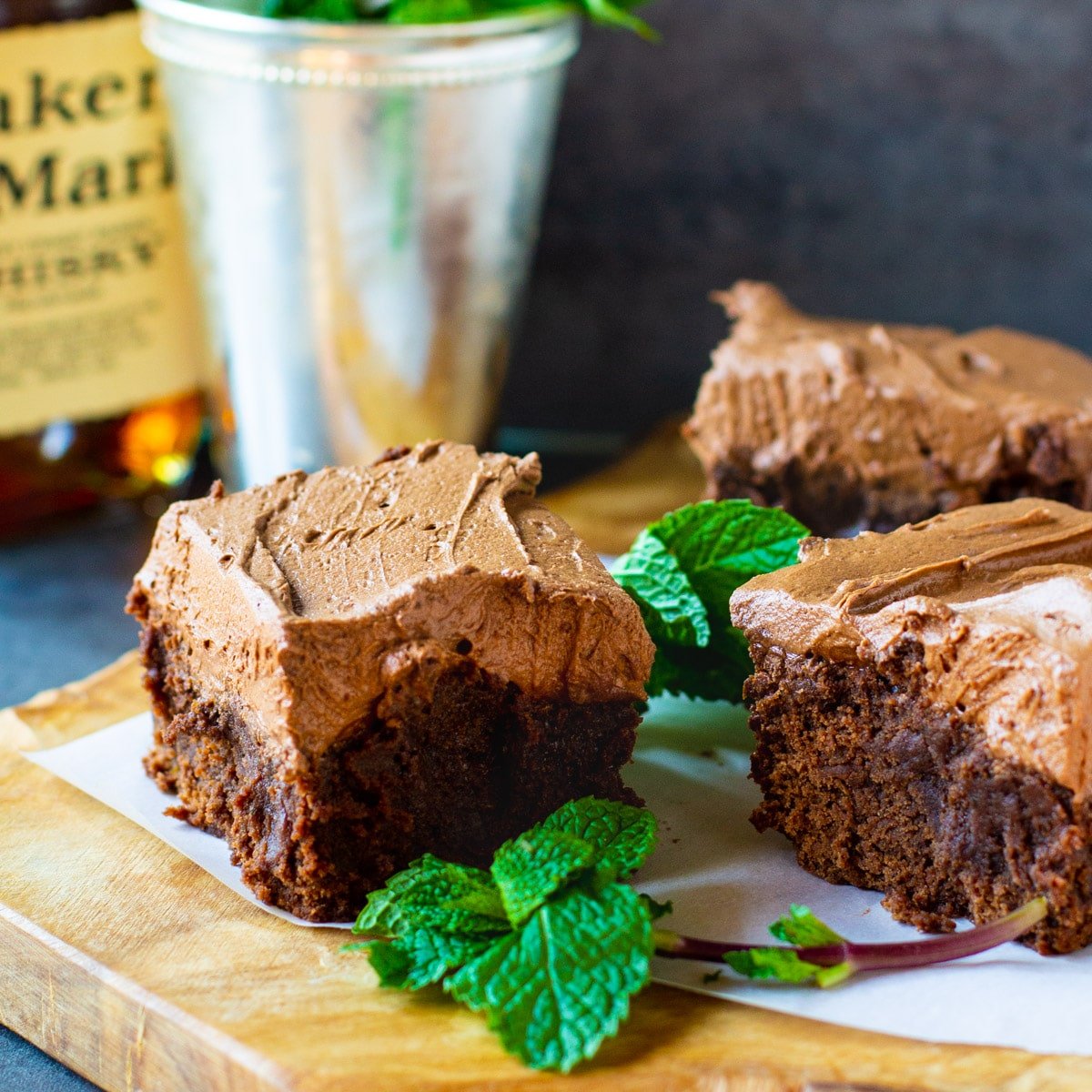 Mint Julep Brownies on a cutting board with fresh mint.