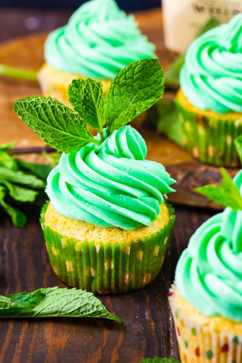 Mint Julep Cupcakes decorated with green icing and mint sprigs.