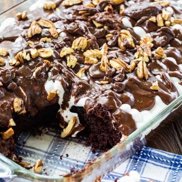 Mississippi Mud Cake in a 9x13-inch pan with piece cut out.