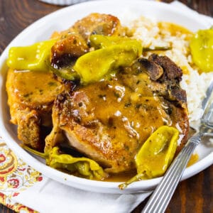 Two Slow Cooker Mississippi Pork Chops on a plate.