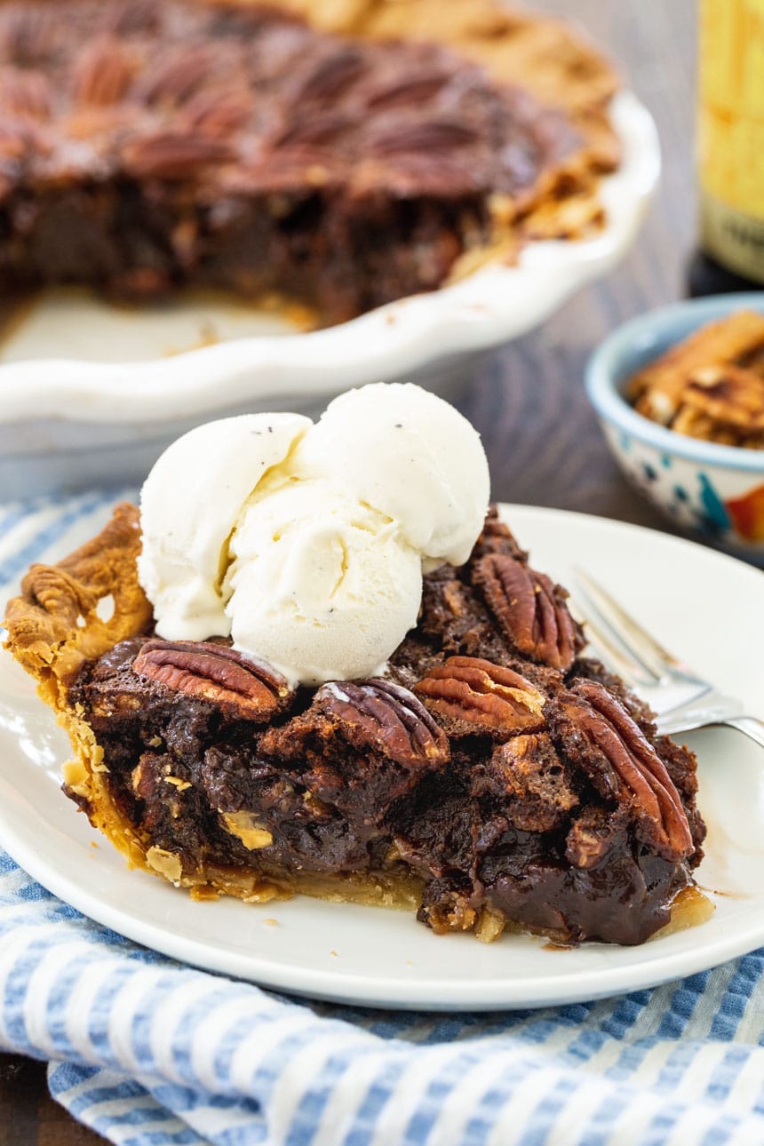 Slice of Mocha Pecan Pie topped with ice cream.