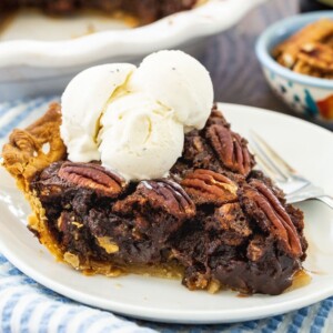 Slice of pie topped with ice cream.