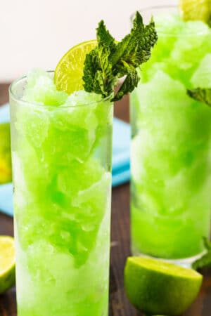 Mojito Slushies in tall glasses with fresh mint.
