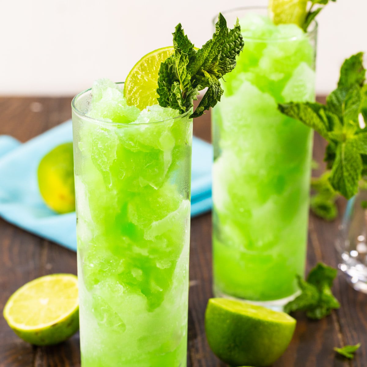 Mojito Slushies in tall glasses with fresh mint.