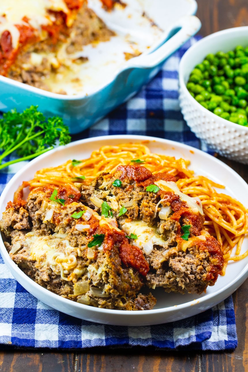 Mozzarella Stuffed Meatloaf slices on a plate with pasta.