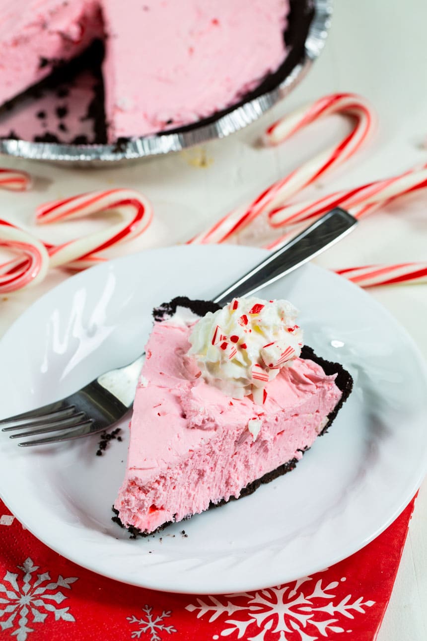 Slice of pie on a plate with candy canes.