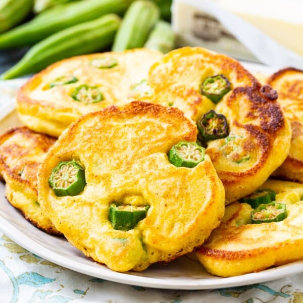 Okra Hoecakes piled up on a plate.