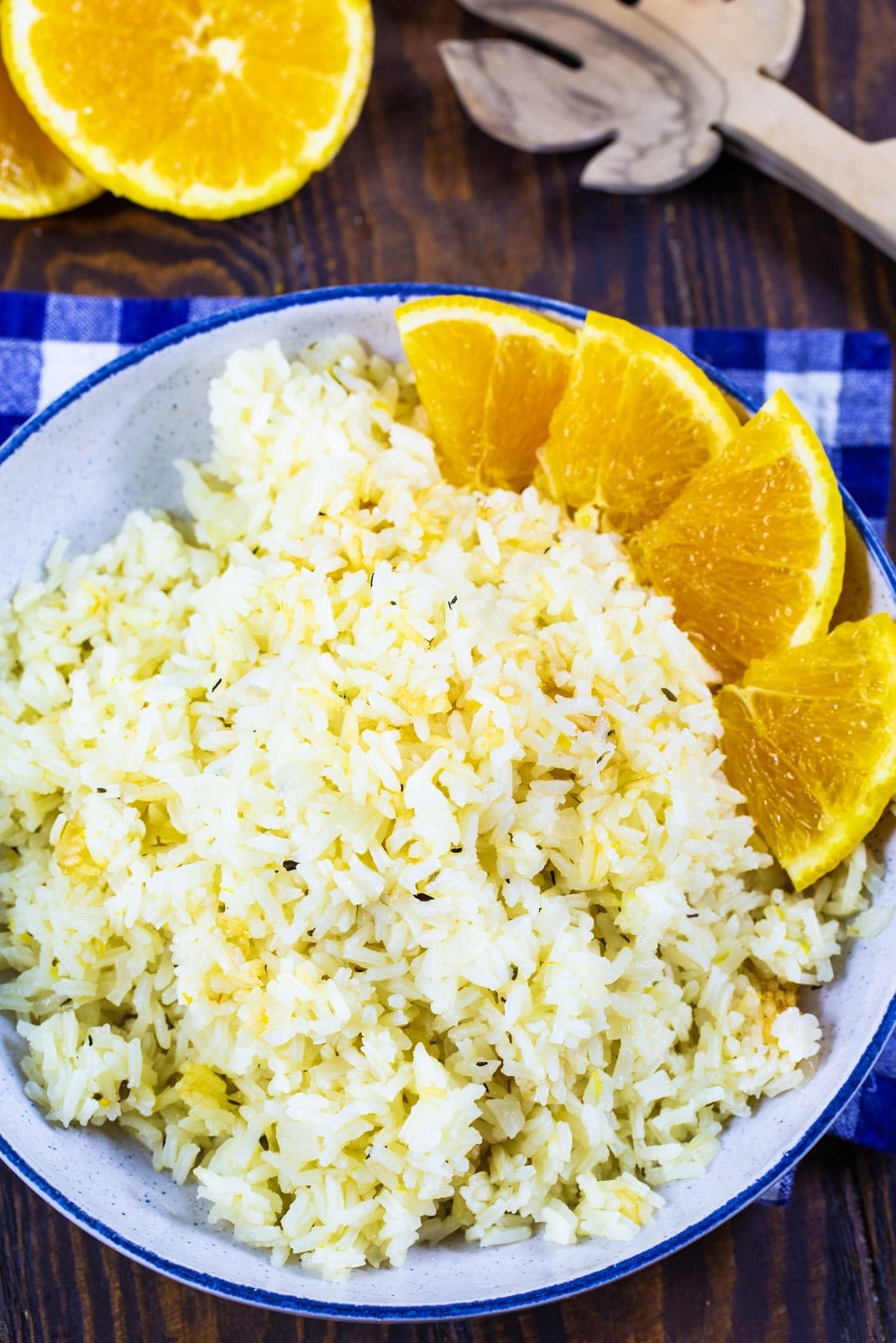 Rice in a bowl with orange slices next to it.