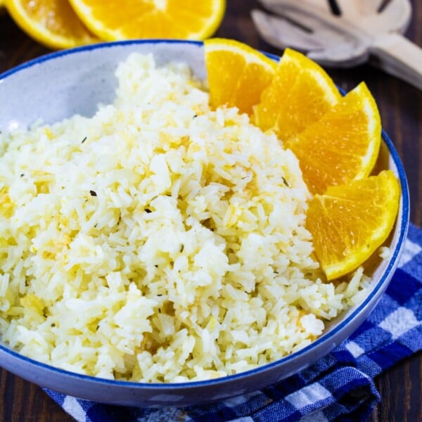 Orange Rice in a blue bowl with orange segments around edge.