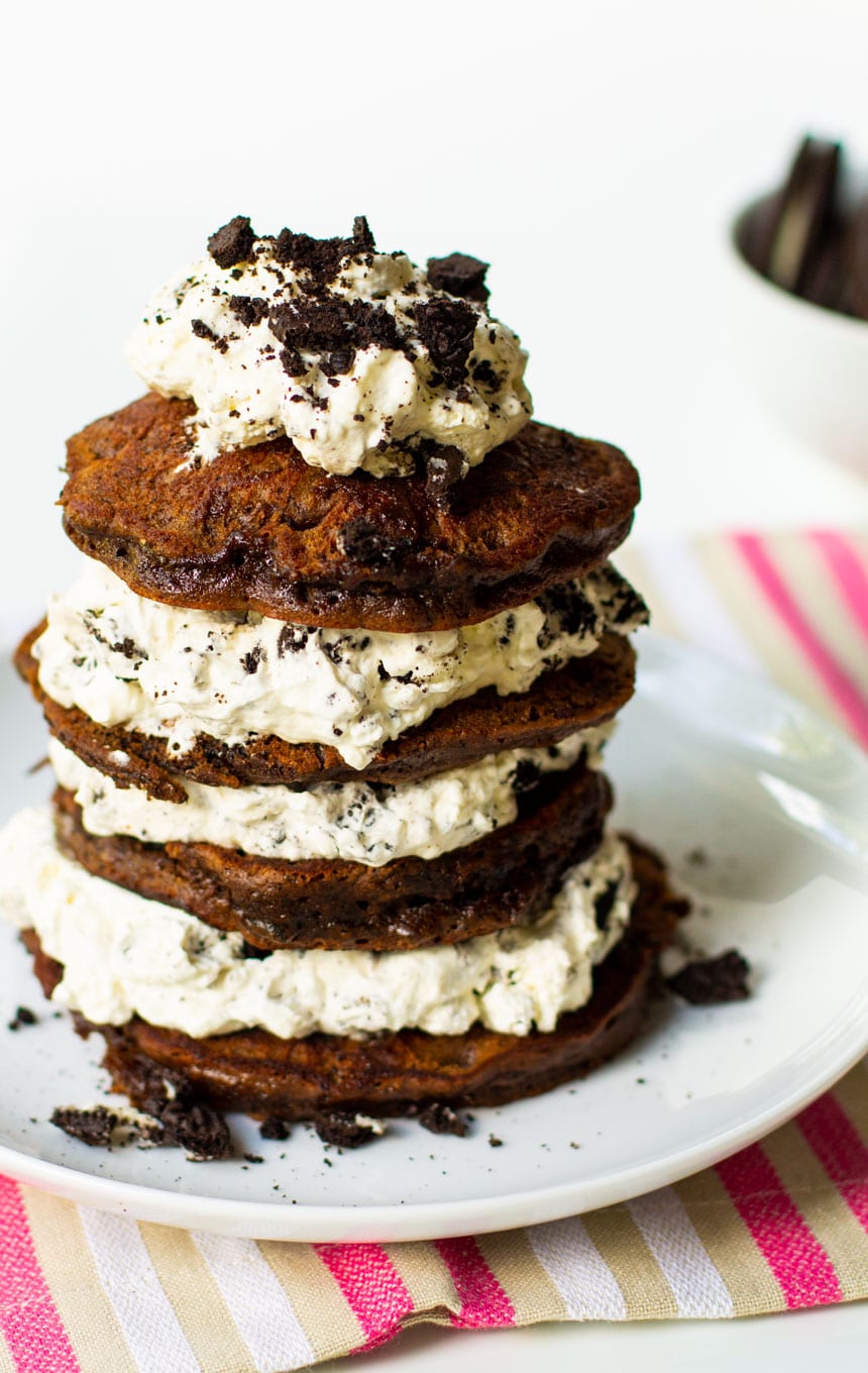 Double Stuff Oreo Pancakes on a plate topped with whipped cream.