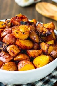 Bowl full of potatoes cooked with paprika.