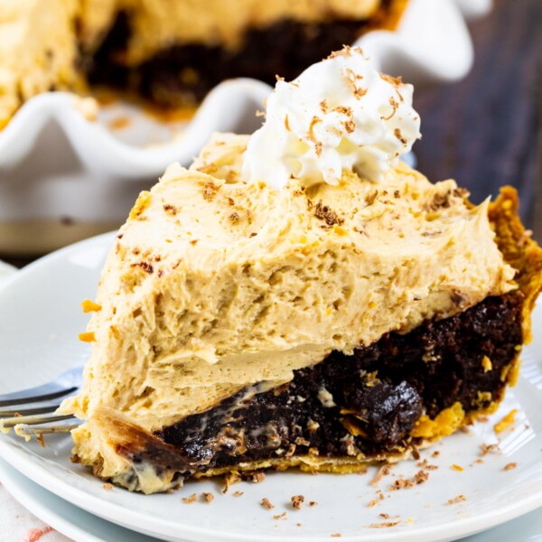 Slice of Peanut Butter Mousse Brownies Pie on a plate.