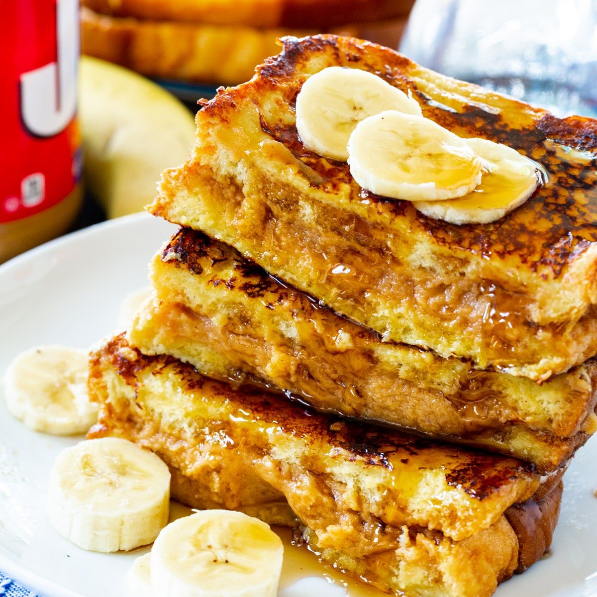 Peanut Butter Stuffed French Toast stacked on a plate.