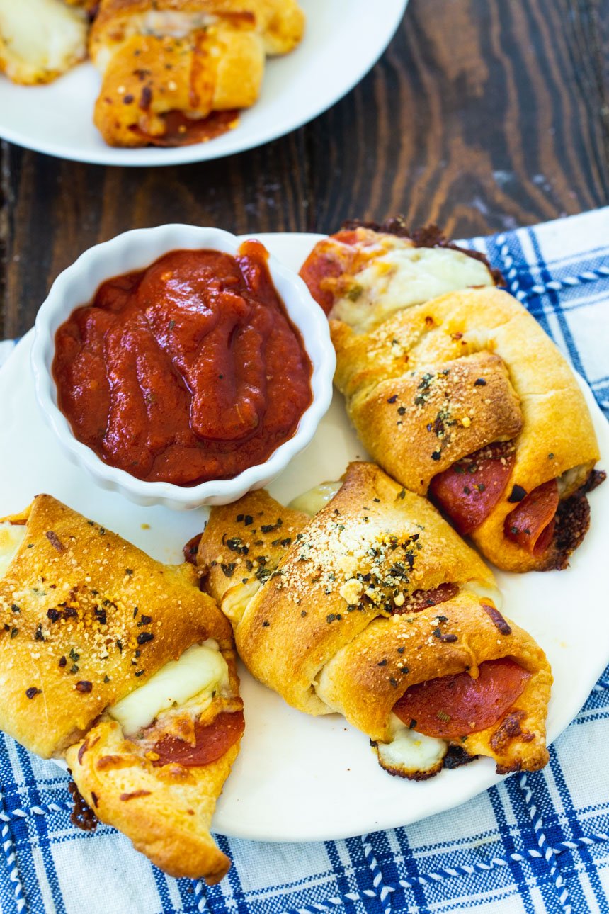 Three Pepperoni Crescent Rolls on a plate.