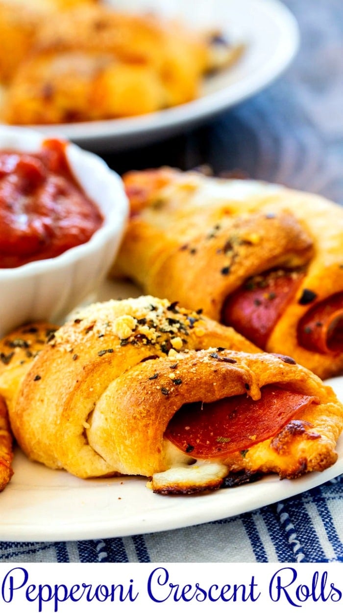 Pepperoni Crescent Rolls on a white plate with pizza dip.