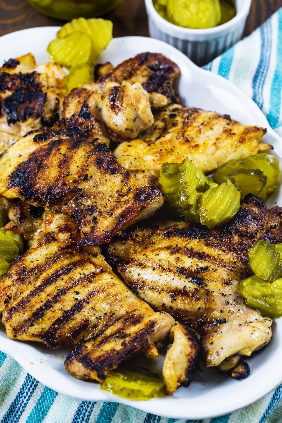Grilled chicken thighs on serving platter.