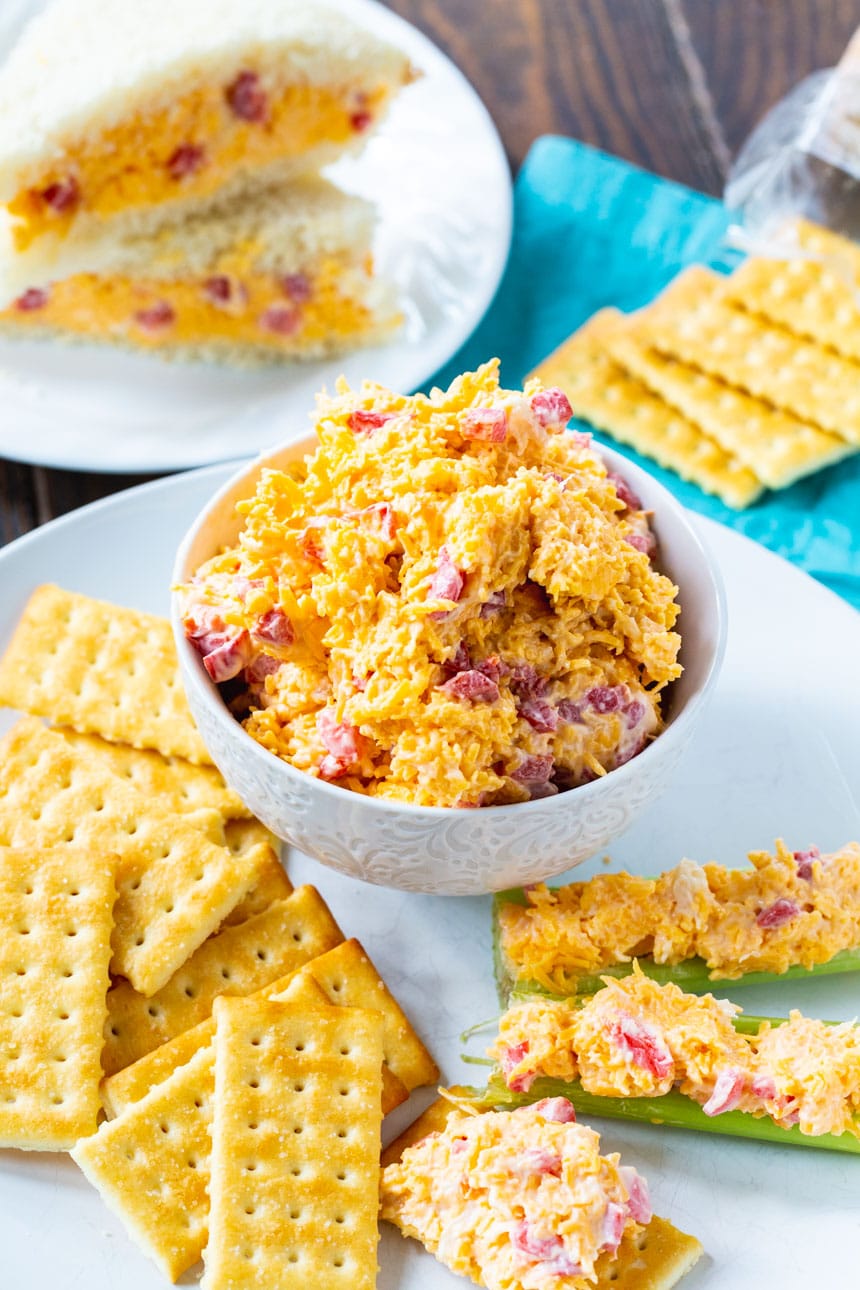 Bowl full of pimento cheese surrounded by crackers.