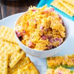 Pimento Cheese in a bowl surronded by crackers.