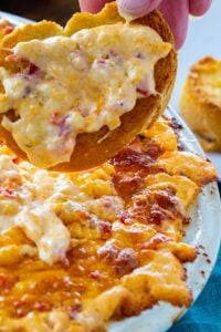 Baked Pimento Cheese Dip on a piece of toasted baguette.