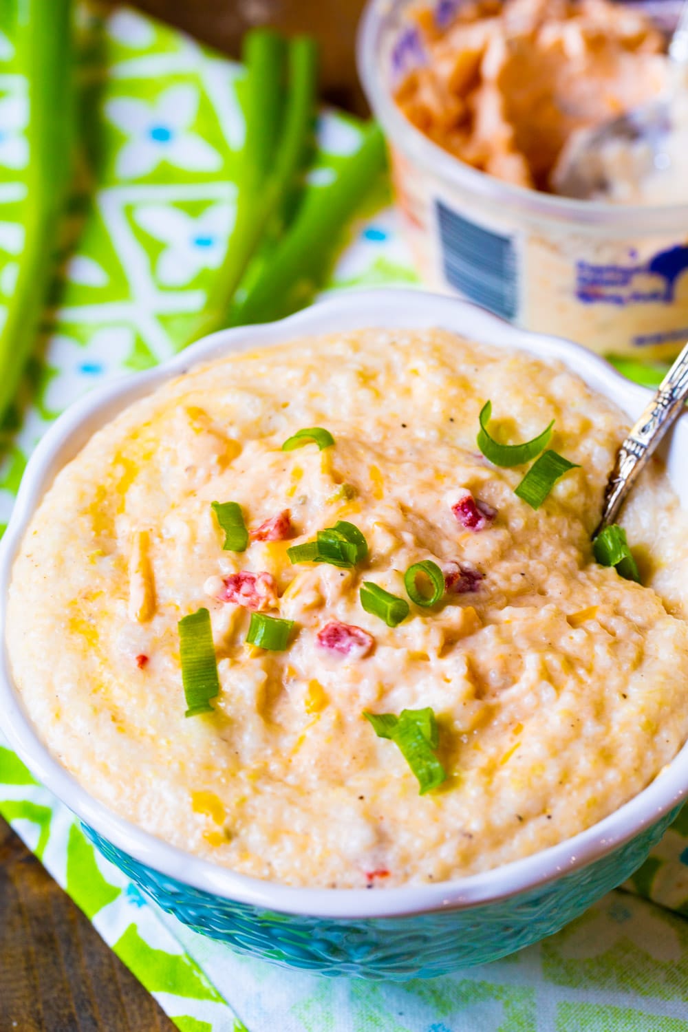 Grits with pimento cheese in a blue bowl.