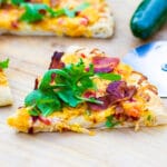 Slice of Pimento Cheese Pizza topped with Arugula