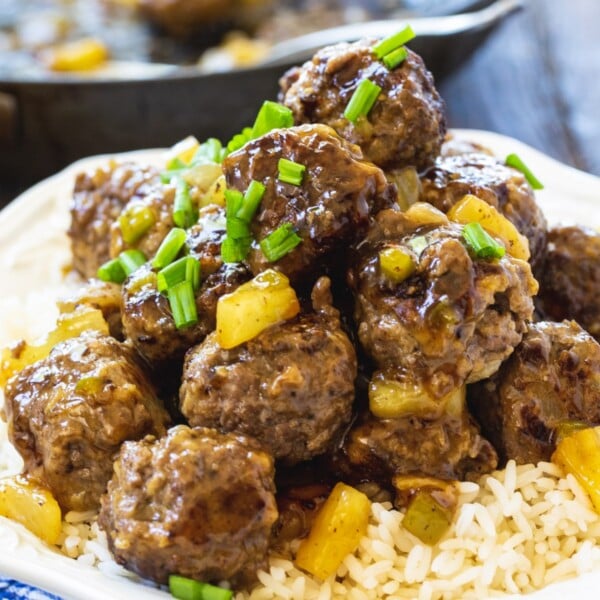 Polynesian Meatballs over rice on a plate.