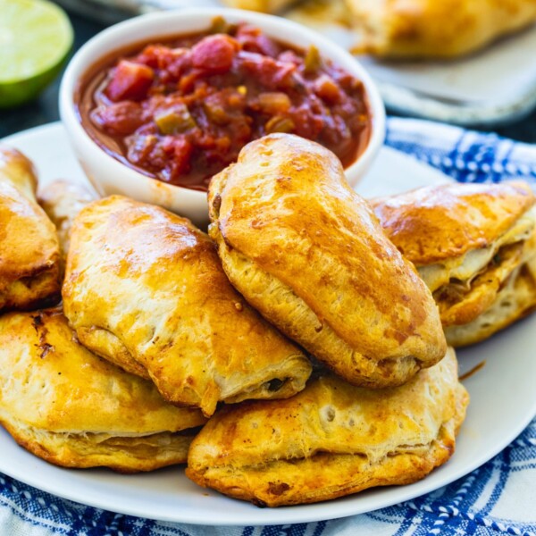 Pork Picadillo Empanadas on a plate with small bowl of salsa.