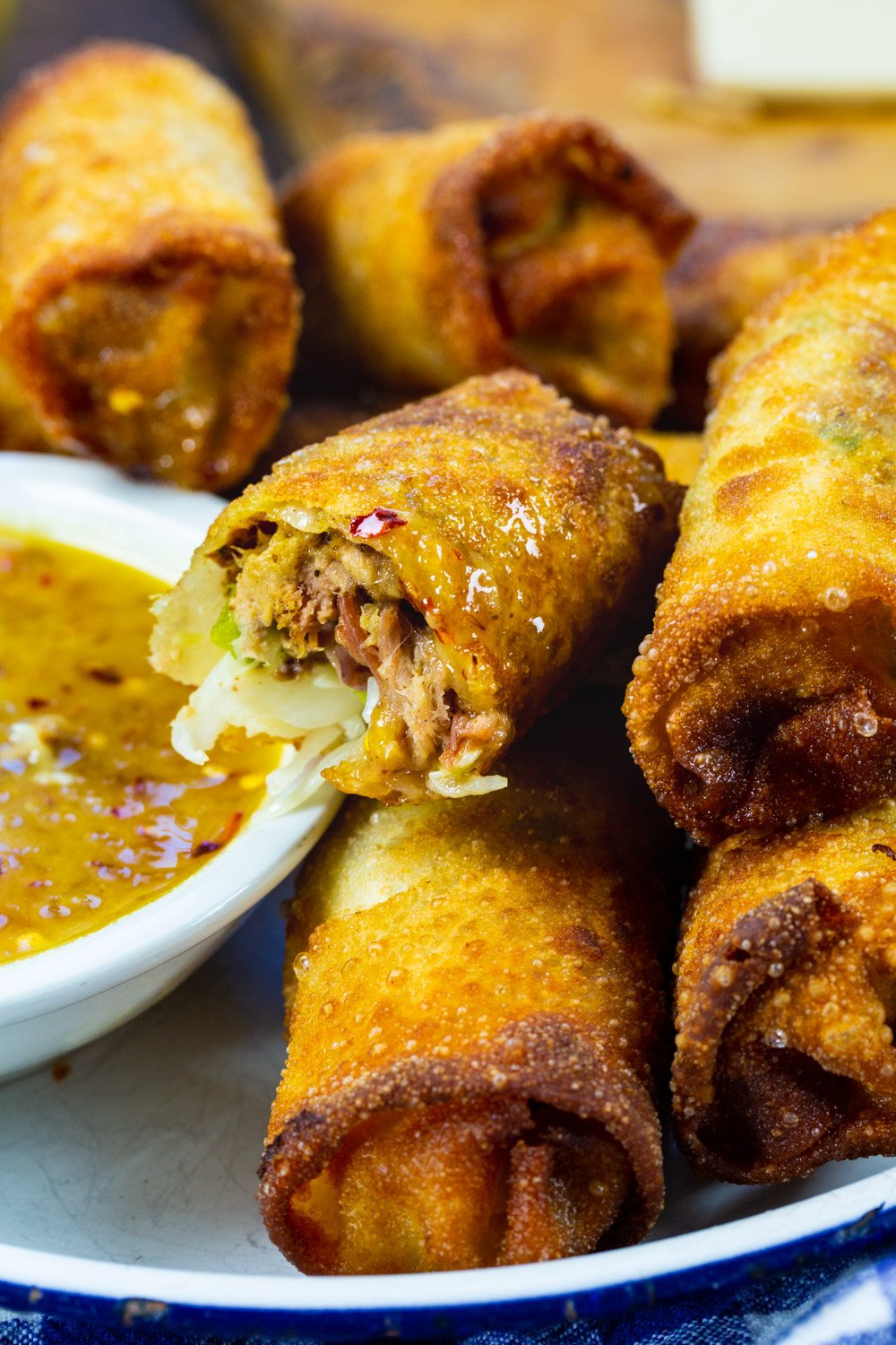 Pulled Pork Egg Roll dipped into tangy peach dipping sauce.