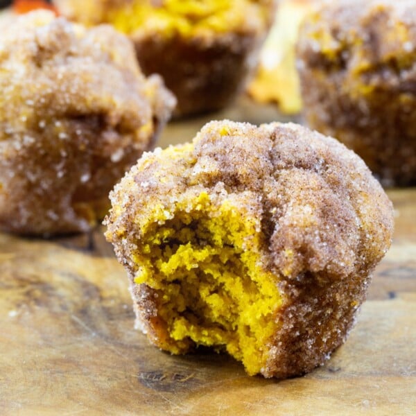 Pumpkin Doughnut Muffins with a bite taken out.