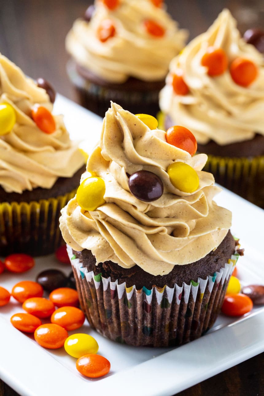 Cupcakes on a plate with Reese's Pieces.