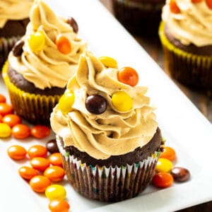 Chocolate Reese's Cupcakes topped with peanut butter frosting on a serving platter.