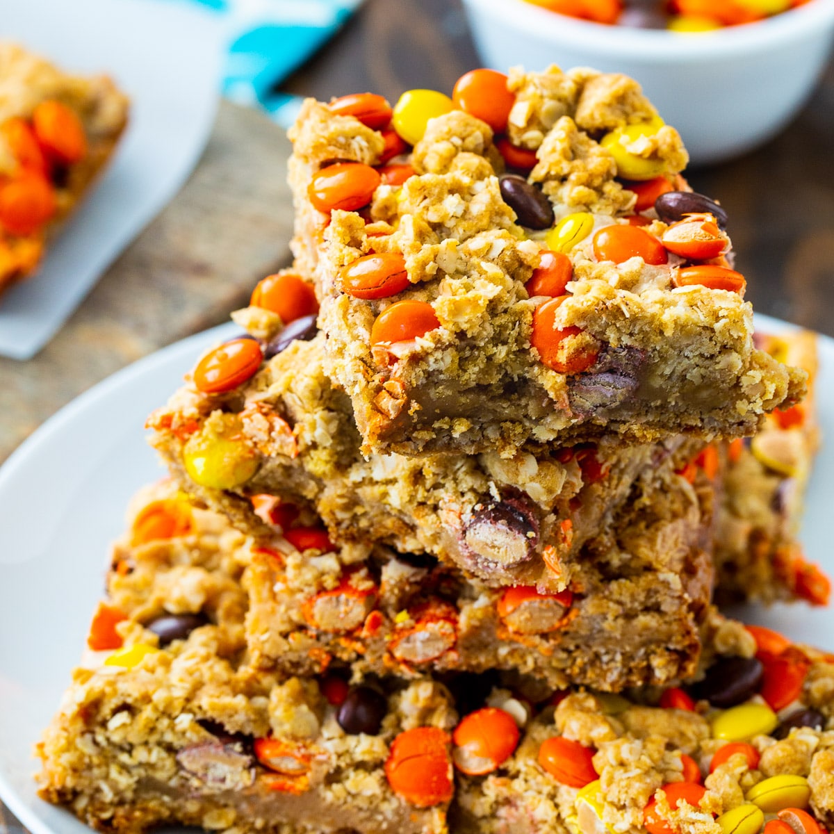 Reese's Pieces Oatmeal Bars stacked on a plate.