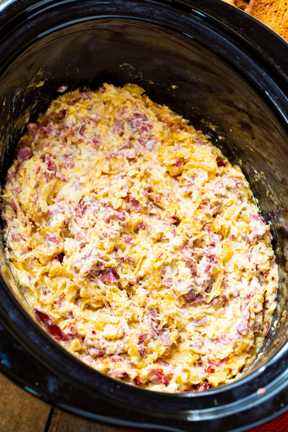 Reuben Dip in a black slow cooker.